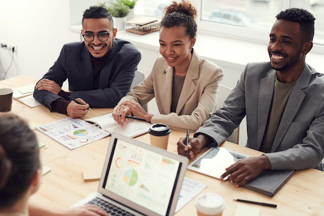 a group of people making a financial plan looking over graphs