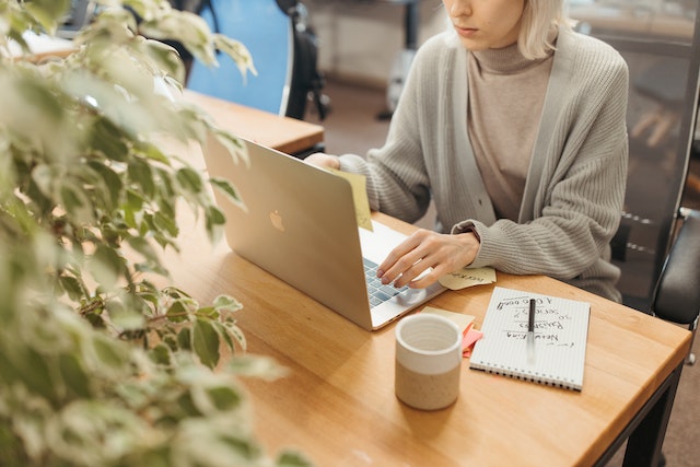 a landlord in-a grey sweater researches rental market updates while having a coffee