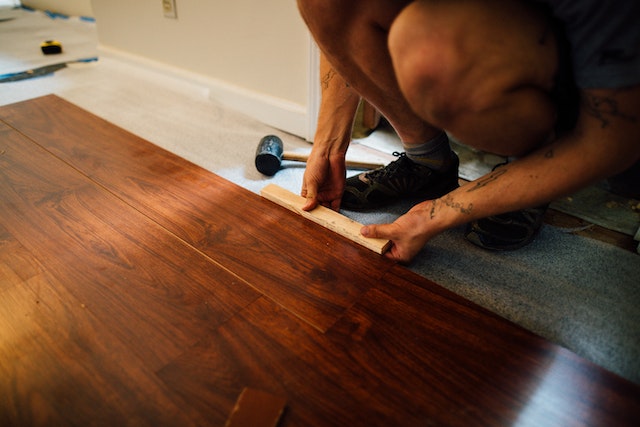 A licenced contractor installs durable cherry hardwood floors in a rental property