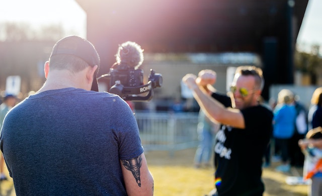 a saskatchewan filmmaker holding a camera shoots content for their upcoming documentary film