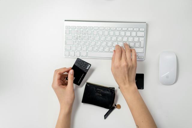 hand holding a credit card to make an online payment