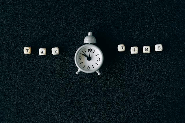 letter cubes spelling out tax time with a click in between