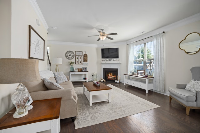 living room with white accents and dark wood flooring