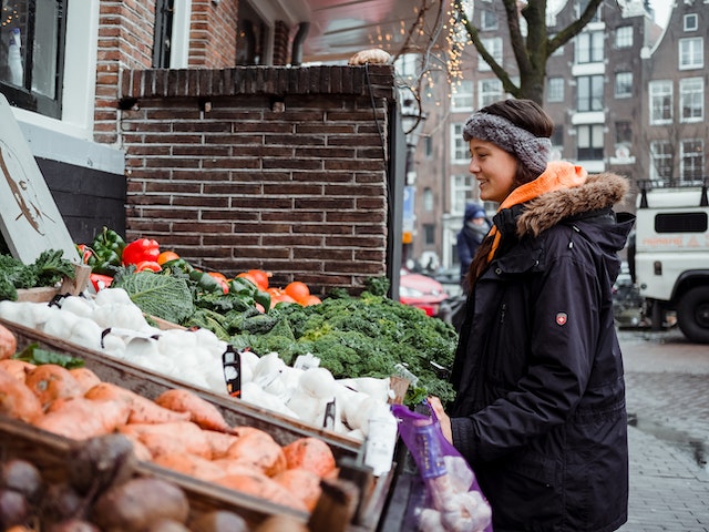 person at an outdoor farmers market